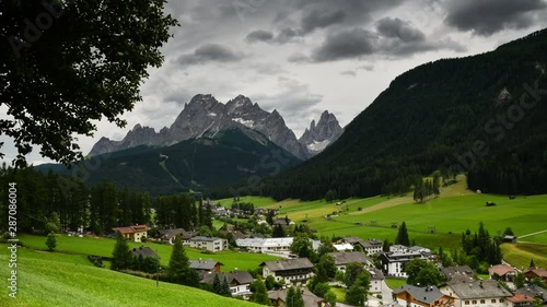 Beautiful landscape of Sesto Pusteria in Val Fiscalina with the Cima Dodici or Zwölferkofel dolomitic group on background. Sexten Dolomites, South Tyrol. Italy. Timelapse with Tilt camera movement.  photo