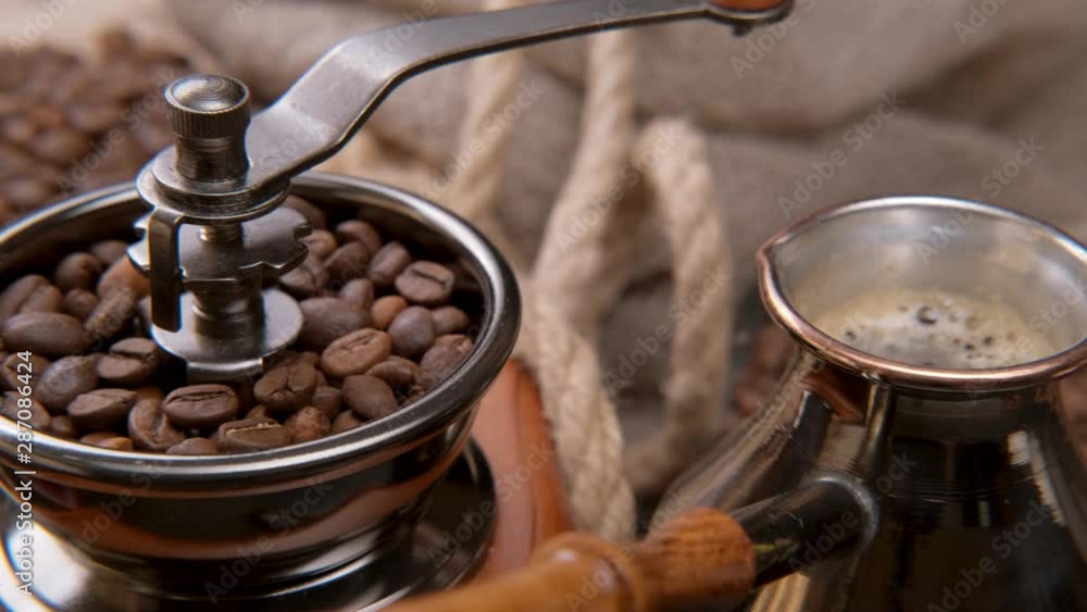 coffee cezve, grinder and cup. Coffee is poured into a cup. 4K sliding coffee cezve, grinder and cup. Coffee is poured into a cup. 4K sliding