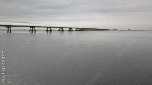 Aerial shot of a beam bridge over an inlet to the Bearing Sea in Nome, Alaska. photo