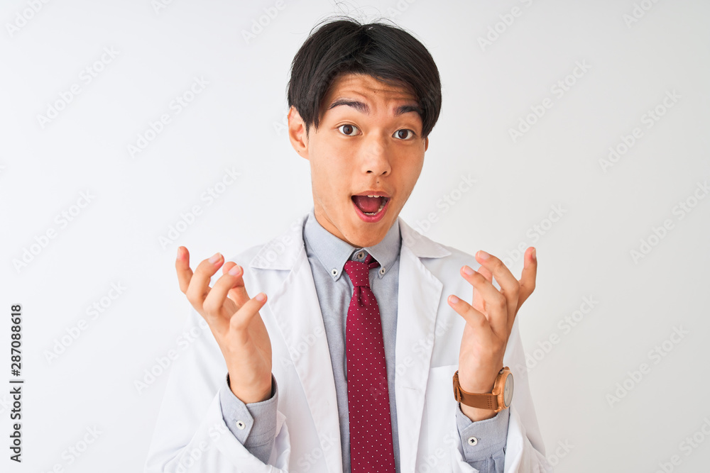 Chinese scientist man wearing tie and coat standing over isolated white background celebrating crazy and amazed for success with arms raised and open eyes screaming excited. Winner concept Chinese scientist man wearing tie and coat standing over isolated white background celebrating crazy and amazed for success with arms raised and open eyes screaming excited. Winner concept