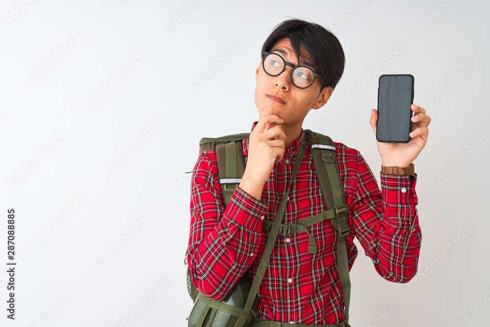 Chinese hiker man wearing canteen holding smartphone over isolated white background serious face thinking about question, very confused idea Chinese hiker man wearing canteen holding smartphone over isolated white background serious face thinking about question, very confused idea