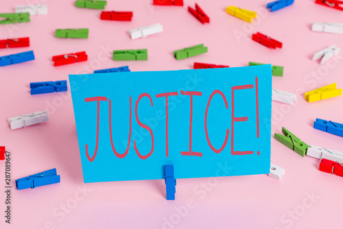 Writing note showing Justice. Business concept for impartial adjustment of conflicting claims or assignments Colored clothespin papers empty reminder pink floor office pin photo