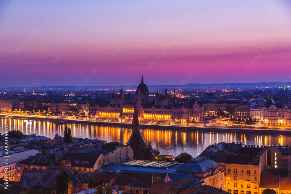 Panoramic cityscape of Hungarian parliament building on the Danube river. Colorful sunrise in Budapest, Hungary