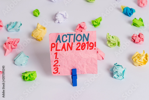 Conceptual hand writing showing Action Plan 2019. Concept meaning proposed strategy or course of actions for current year Colored crumpled paper empty reminder white floor clothespin