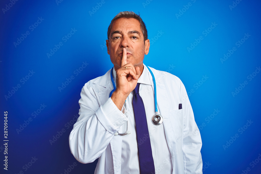 Handsome middle age doctor man wearing stethoscope over isolated blue background asking to be quiet with finger on lips. Silence and secret concept. Handsome middle age doctor man wearing stethoscope over isolated blue background asking to be quiet with finger on lips. Silence and secret concept.