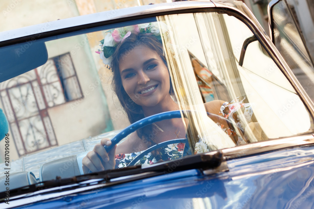 Naklejka premium Beautiful woman driving a retro convertible car