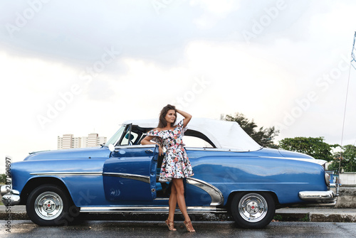 Canvas Print Beautiful woman driving a retro convertible car