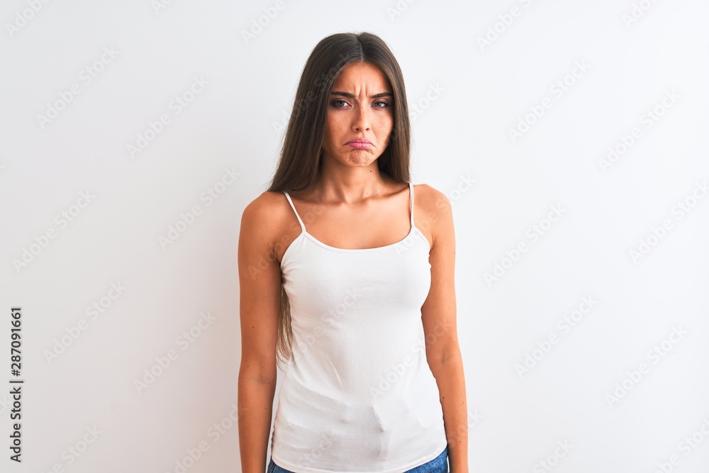 Young beautiful woman wearing casual t-shirt standing over isolated white background depressed and worry for distress, crying angry and afraid. Sad expression. Young beautiful woman wearing casual t-shirt standing over isolated white background depressed and worry for distress, crying angry and afraid. Sad expression.