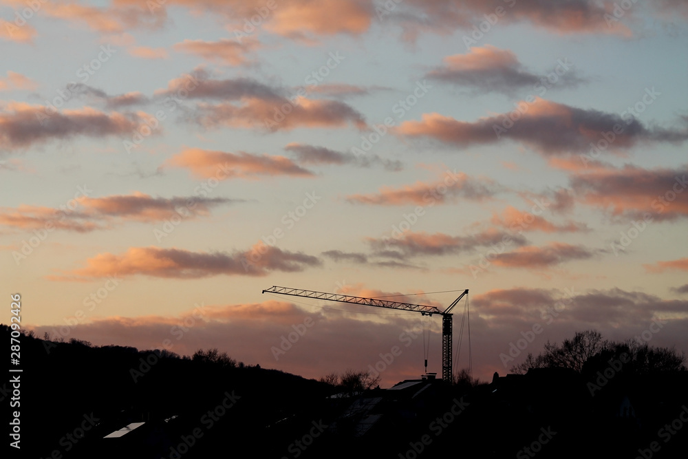 Crane at a construction site at sunset