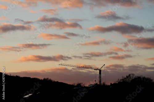 Crane at a construction site at sunset