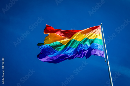 Enormous 20x30 foot rainbow flag flying proud over Harvey Milk Plaza in the Castro district of San Francisco California