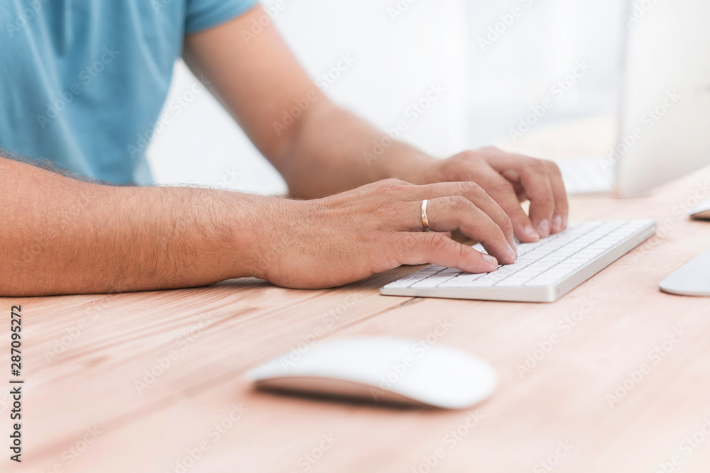 close up. a man typing on a computer keyboard