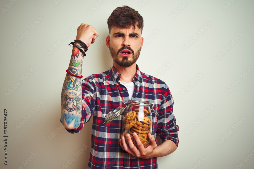 Young man wearing bathrobe drinking cup of coffee standing over isolated white background annoyed and frustrated shouting with anger, crazy and yelling with raised hand, anger concept Young man wearing bathrobe drinking cup of coffee standing over isolated white background annoyed and frustrated shouting with anger, crazy and yelling with raised hand, anger concept