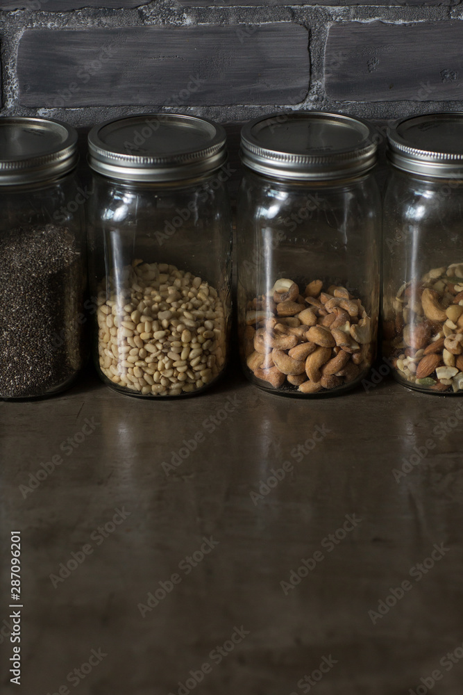 jars of nuts in dark rustic kitchen jars of nuts in dark rustic kitchen