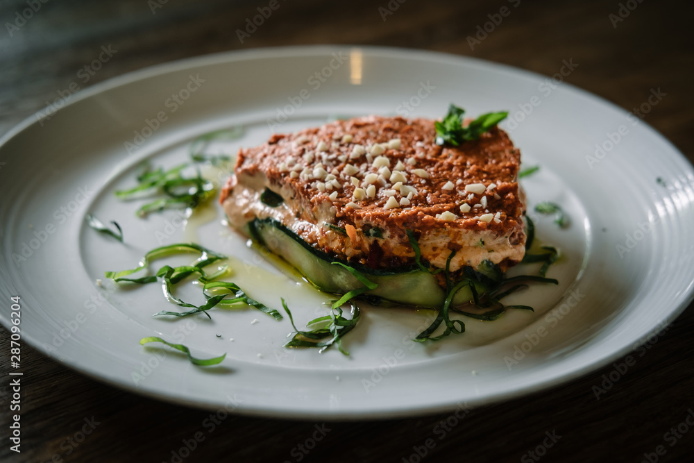Raw vegan lasagna on a white plate. Dairy free, gluten free food.