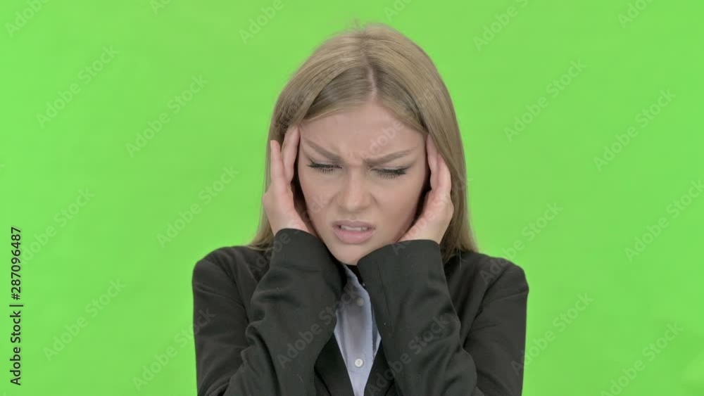 Tired Young Businesswoman having Headache against Chroma Key Tired Young Businesswoman having Headache against Chroma Key