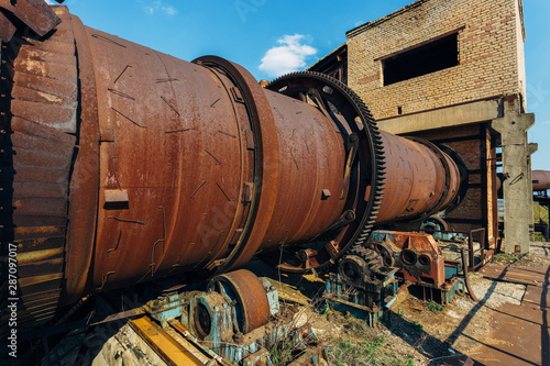 Old rusty rotating kiln in cement manufacturing plant