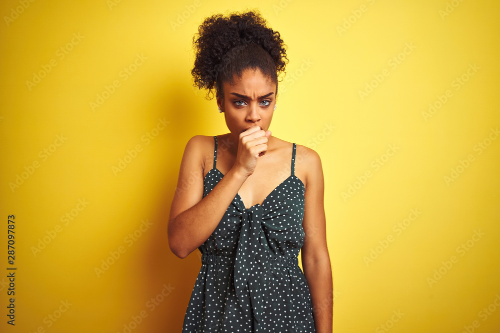African american woman wearing summer casual green dress over isolated yellow background feeling unwell and coughing as symptom for cold or bronchitis. Healthcare concept. African american woman wearing summer casual green dress over isolated yellow background feeling unwell and coughing as symptom for cold or bronchitis. Healthcare concept.