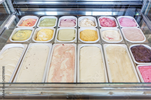 boxes of different types and tastes of ice cream in a modern store