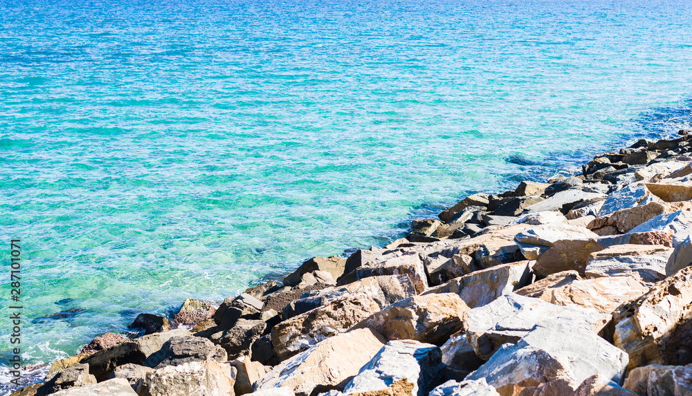 Amazing beautiful blue ocean and rocks on a sunny day, natural outdoor landscape by the beach Amazing beautiful blue ocean and rocks on a sunny day, natural outdoor landscape by the beach