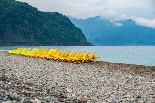 beautiful view of the stony beach in kvariati, Adjara. deck chairs on the beach. photo