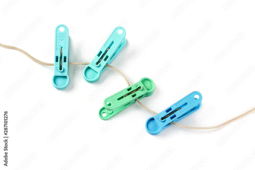 colorful plastic clothespins with a rope isolated on white colorful plastic clothespins with a rope isolated on white