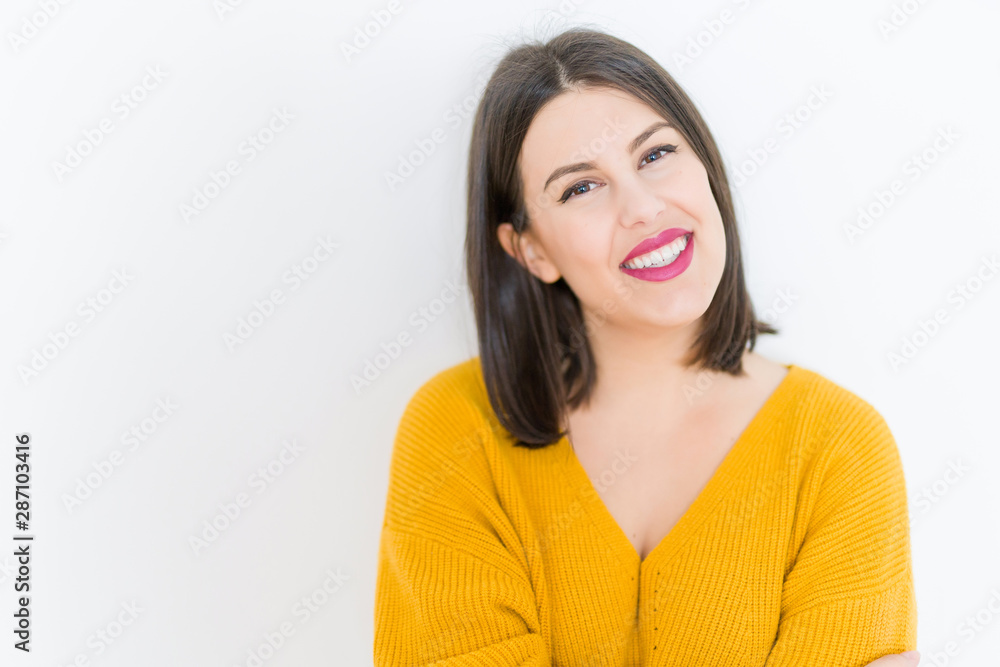 Beautiful brunette young woman smiling confident and cheerful over isolated white background wearing casual yellow sweater Beautiful brunette young woman smiling confident and cheerful over isolated white background wearing casual yellow sweater