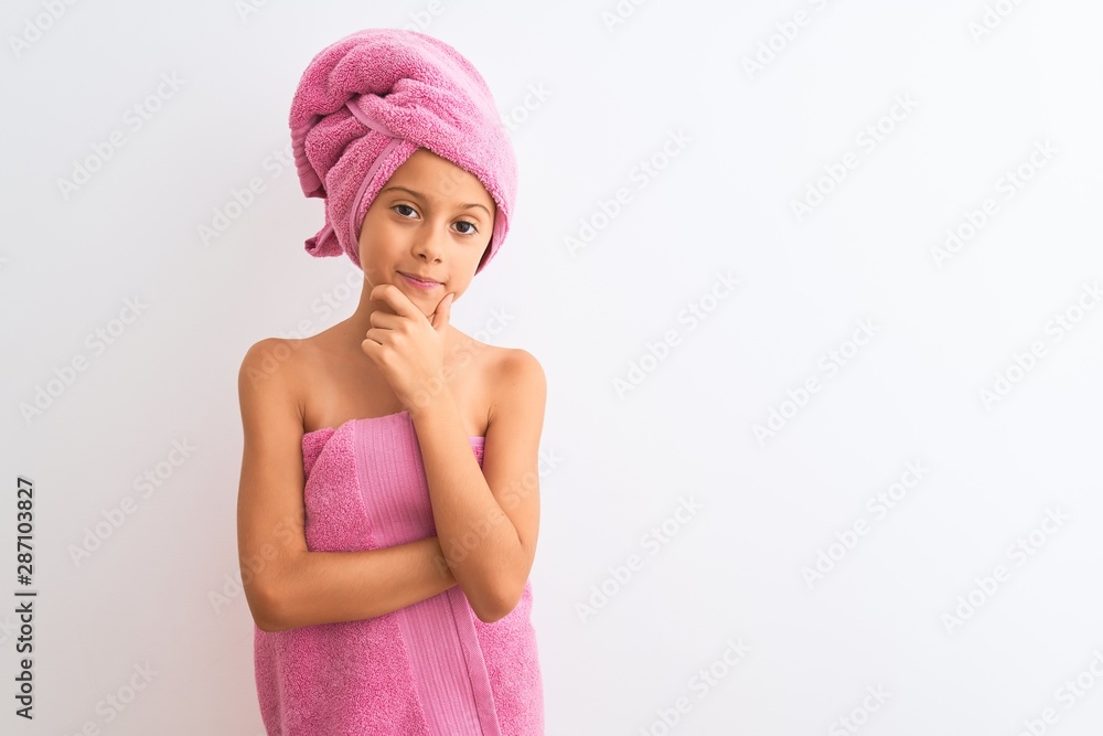 Beautiful child girl wearing shower towel after bath standing over isolated white background looking confident at the camera smiling with crossed arms and hand raised on chin. Thinking positive. Beautiful child girl wearing shower towel after bath standing over isolated white background looking confident at the camera smiling with crossed arms and hand raised on chin. Thinking positive.