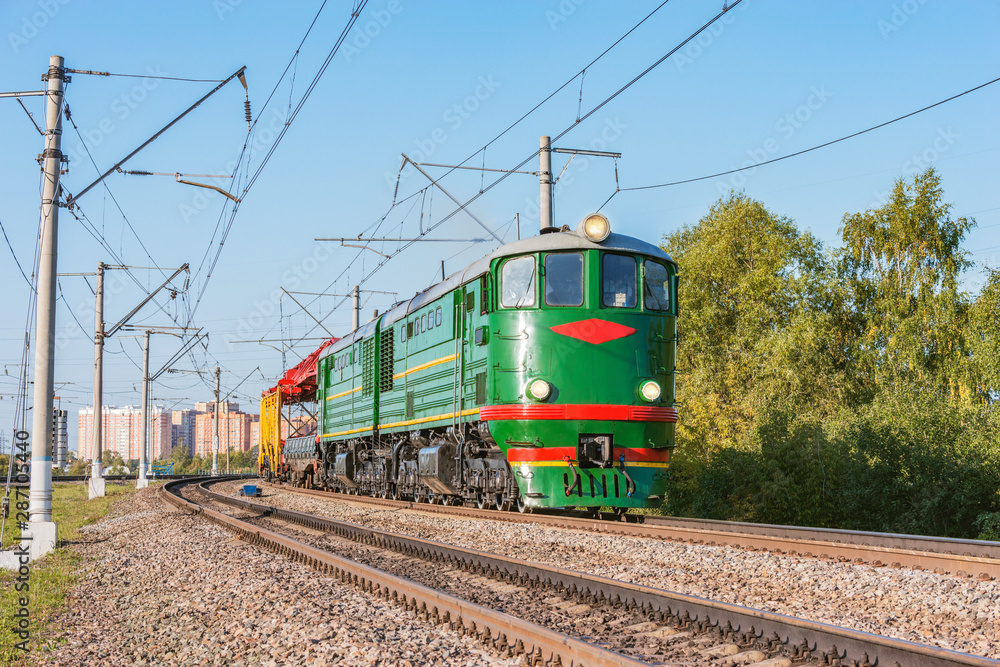 Retro diesel locomotive with freight train at evening time. This type of locomotive was made since 1954. Retro diesel locomotive with freight train at evening time. This type of locomotive was made since 1954.