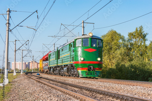 Retro diesel locomotive with freight train at evening time. This type of locomotive was made since 1954.