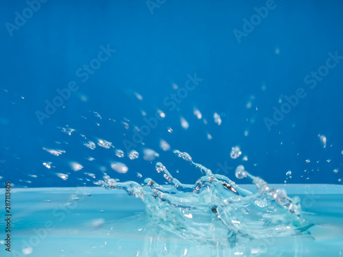 Clean water droplets against the blue background