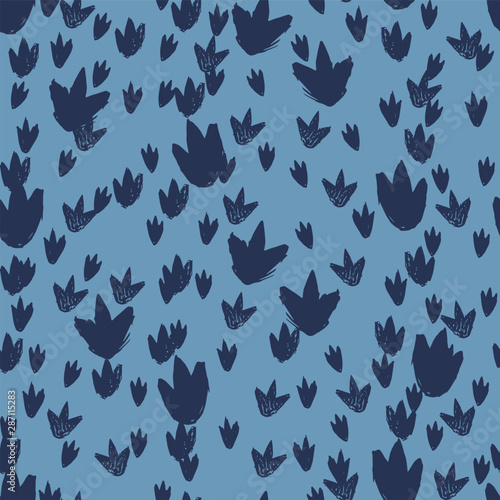 Vector blue dinosaur footprints repeat pattern. Perfect for textile, giftwrap and wallpaper.