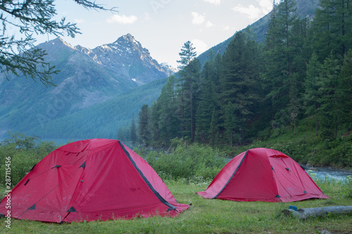 Morning tent camp and lake in amazing mountains 