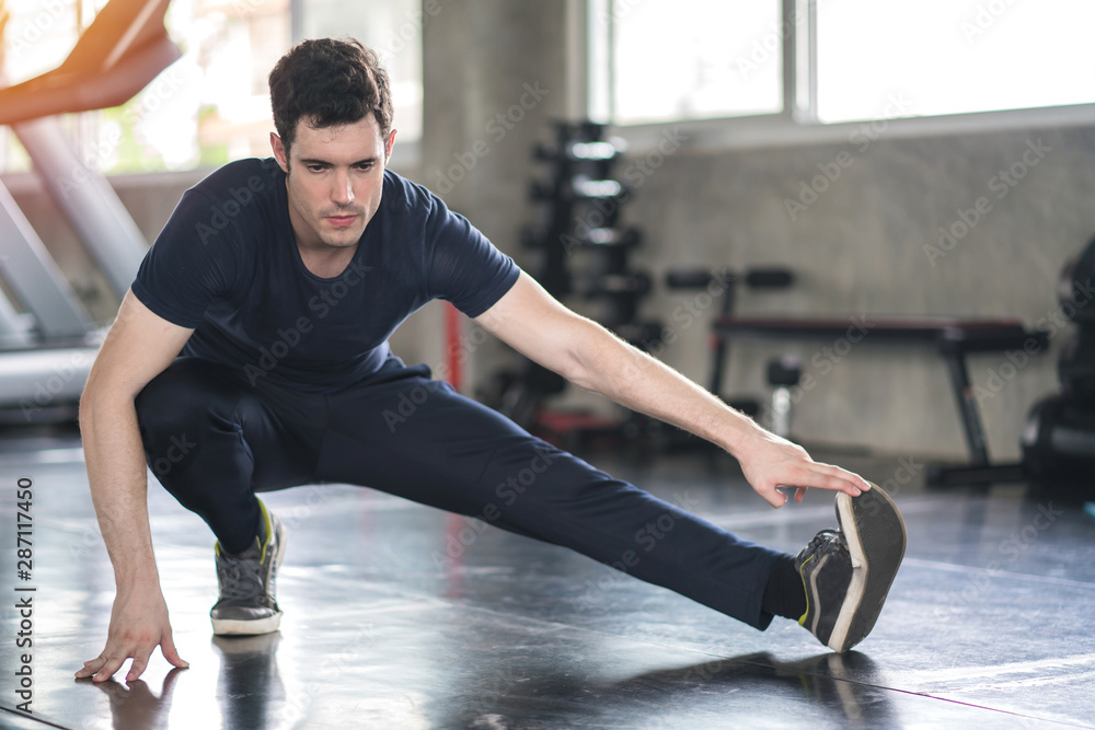 Fototapeta premium Handsome man exercise workout in gym fitness breaking relax and warm up with dumbbell for bodybuilding