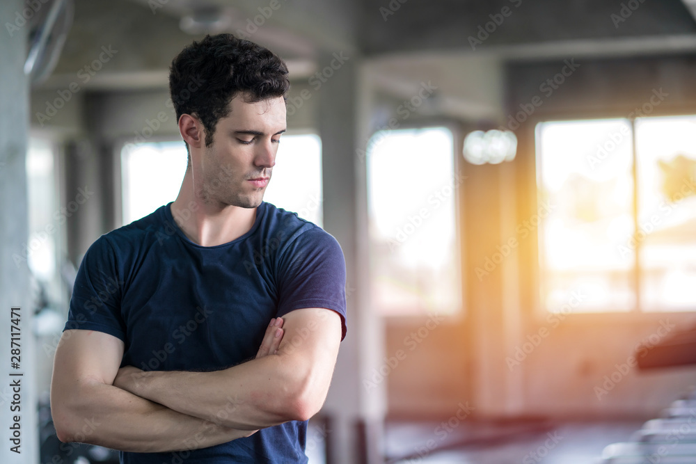 handsome man admiring his muscles in a gym by Concept sport personal trainer and fitness handsome man admiring his muscles in a gym by Concept sport personal trainer and fitness