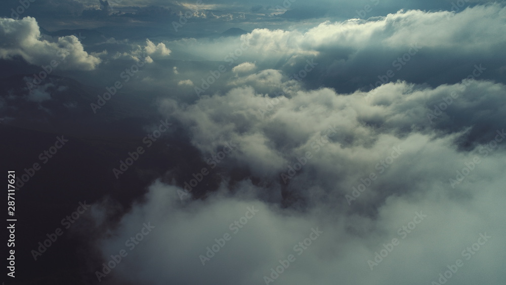 Obraz premium aerial fly above clouds with blue sky in backgroubnd on beautiful sunny day
