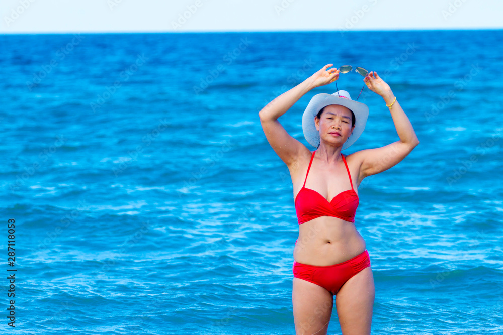 Woman with red bikini shape sexy on beach at Ban Krut