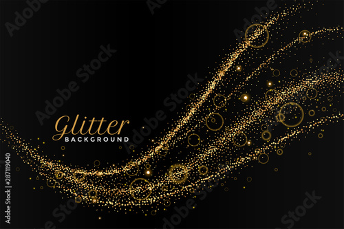 glitterting dust golden trail on black background photo