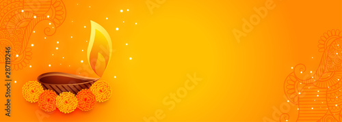 attractive diwali banner with beautiful flowers and diya lamp