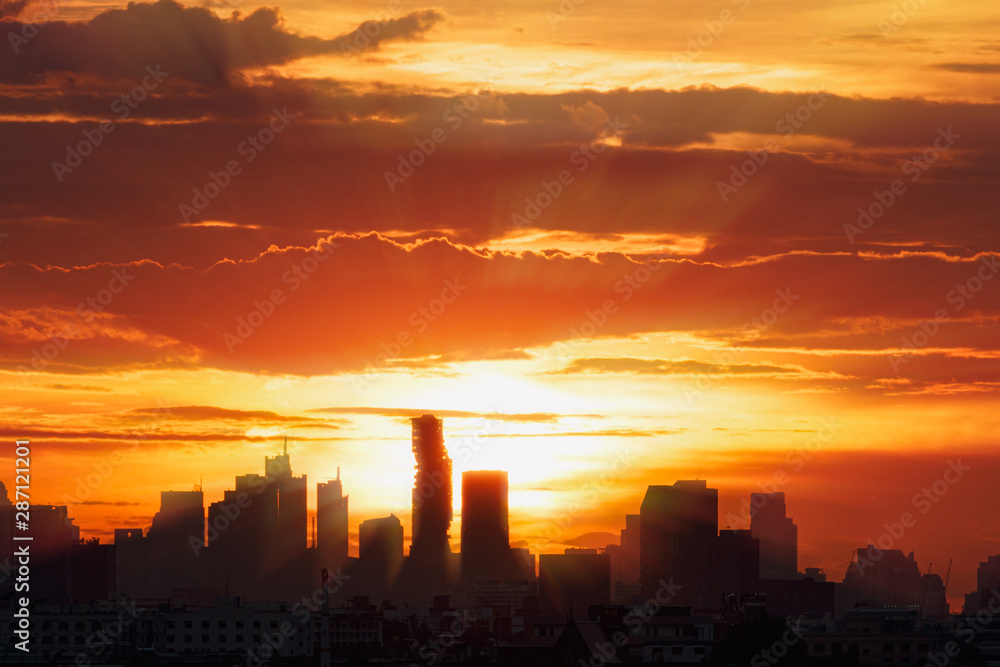 Sun rays with cityscape of building silhouette,At twilight in Bangkok ,Thailand Sun rays with cityscape of building silhouette,At twilight in Bangkok ,Thailand