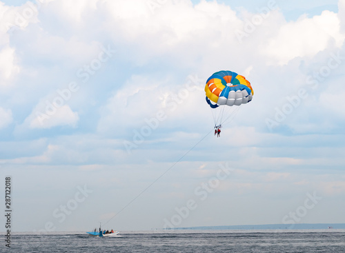 Colorful parasail wing towed by a boat