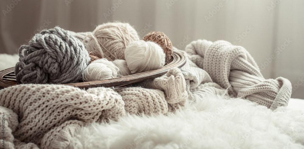 Still life with a cozy variety of yarn for knitting. - obrazy, fototapety, plakaty 