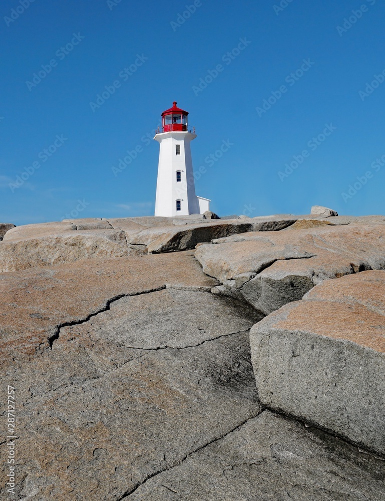 lighthouse at the top of rocky outcropping