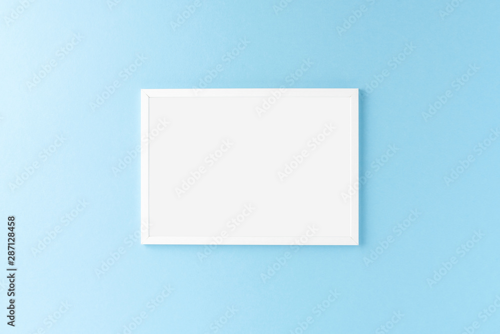 Empty photo frame hanging on blue wall. Mockup Empty photo frame hanging on blue wall. Mockup