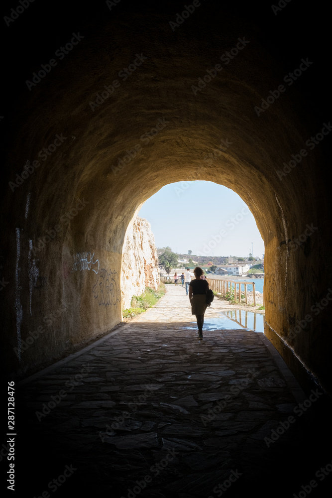 woman coming to light from a tunnel