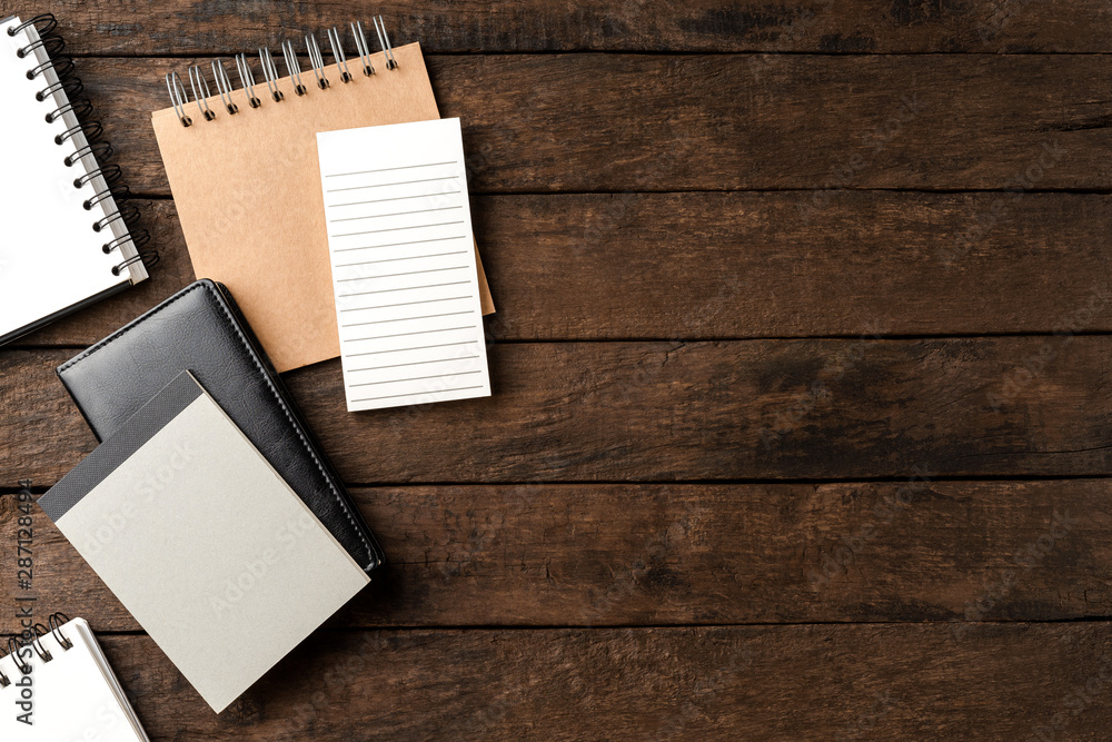 Office desktop concept with various kinds of notebooks on wooden table. Business background Office desktop concept with various kinds of notebooks on wooden table. Business background