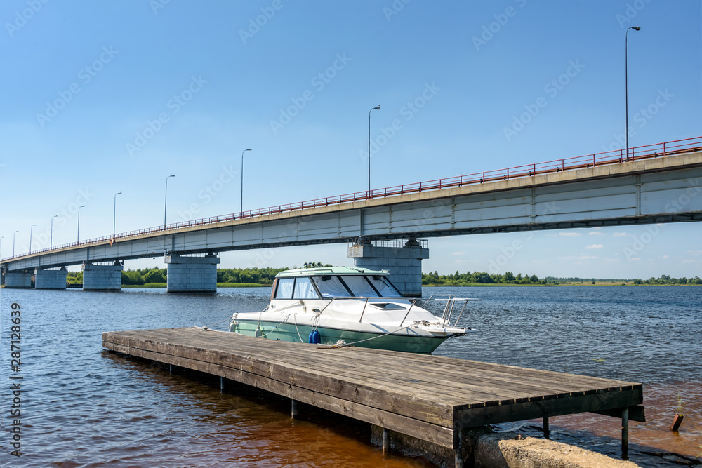 Fototapeta premium The small motorboat at the pier
