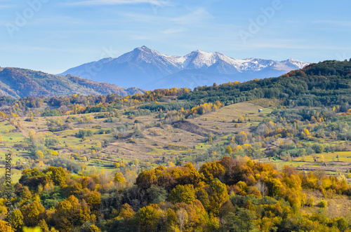 Autumn landscape, when winter slowly descends from the mountain