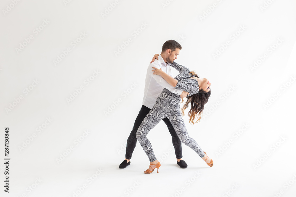 Young love couple dancing social danse kizomba or bachata over white background with copy space Young love couple dancing social danse kizomba or bachata over white background with copy space
