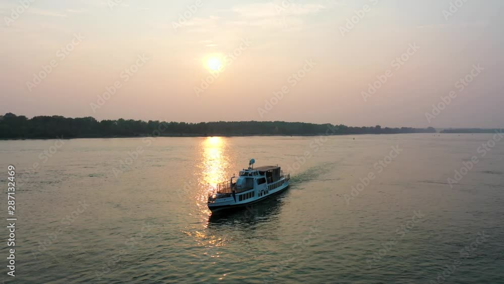 Dawn, a little fog over the river. The ship moves on the river. Beautiful view from above the river Dawn, a little fog over the river. The ship moves on the river. Beautiful view from above the river
